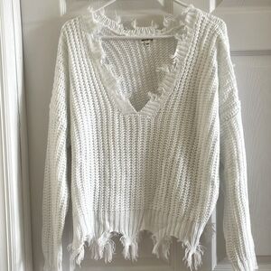 Distressed sweater with fringe